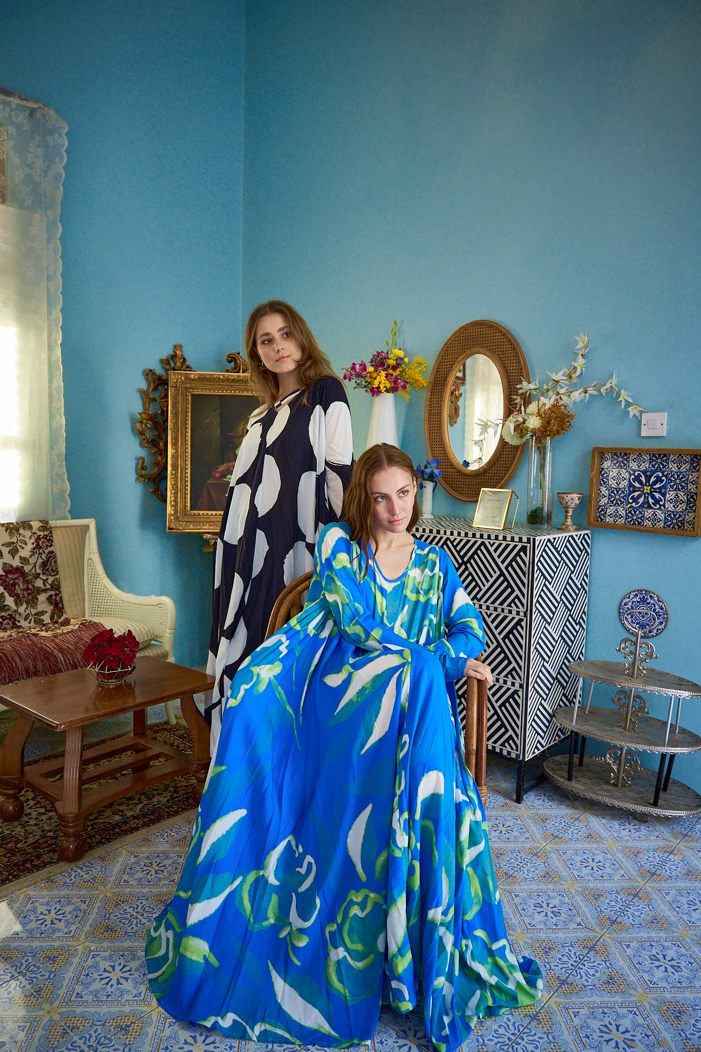 Valeria and Nikola, two stunning models, strike a pose in luxurious Muccii kaftans during a photoshoot in Kuwait.