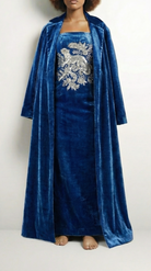 Blue velvet dress with floral embroidery and matching coat on a white background